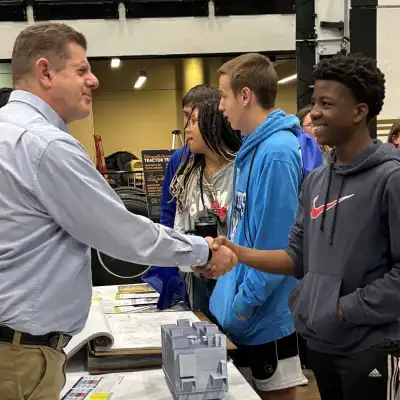 photo of a student greeting an adult