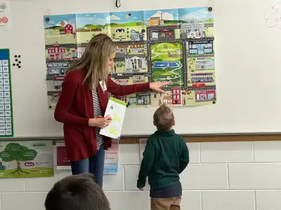 Student and volunteer looking at a map.