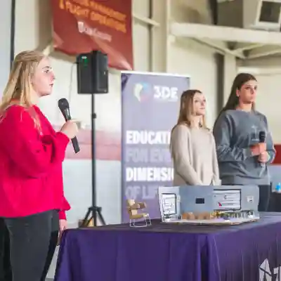 three students receiving award