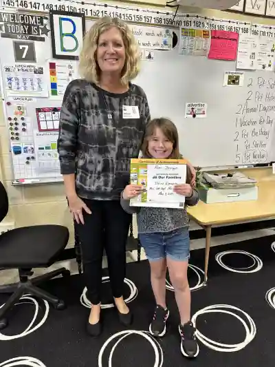 Image of a woman and a student holding a certificate