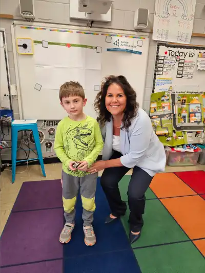 photo of child and woman in classroom