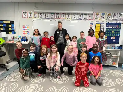 image of volunteer and group of children