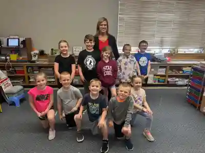 Image of a volunteer with group of students holding certificates