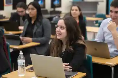 Students working on a laptop.