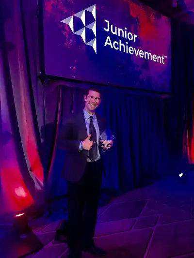 Man in suit receiving an award