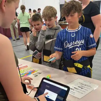 Student handing a debit card to another student