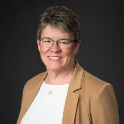 image of a woman in a tan jacket