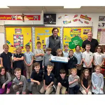 Image of a volunteer talking to students