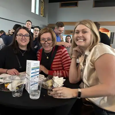 Image of three women around a table